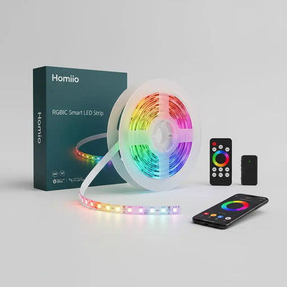 Homiiio RGBIC smart LED strip light set, featuring a spool of flexible RGB LED strip, its dark teal retail box, a smartphone app control screen, a wireless remote, and a small battery pack on a light gray background.